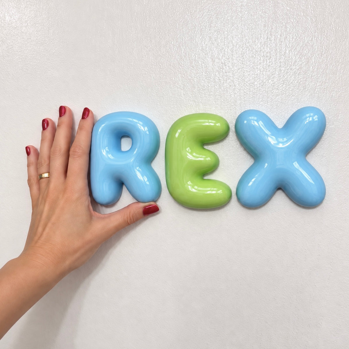 Blue and green personalized 3D bubble name letters with a glossy ceramic-look finish