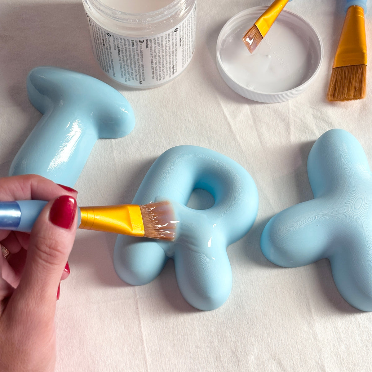 Close-up of glossy 3D bubble letters for a personalized boys nursery or kids room name sign