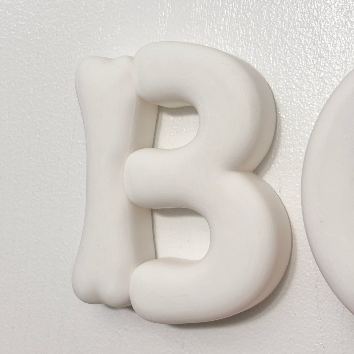 Close-up of chunky rounded 3D BOO letters for Halloween decor