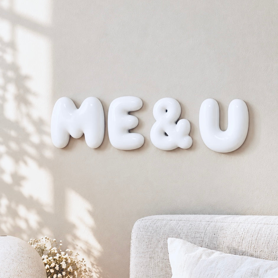 Glossy white ME & U 3D bubble letters displayed as romantic bedroom wall decor by The Homenko Studio, Calgary, Canada