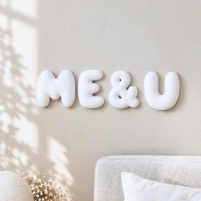 Glossy white ME & U 3D bubble letters displayed as romantic bedroom wall decor by The Homenko Studio, Calgary, Canada